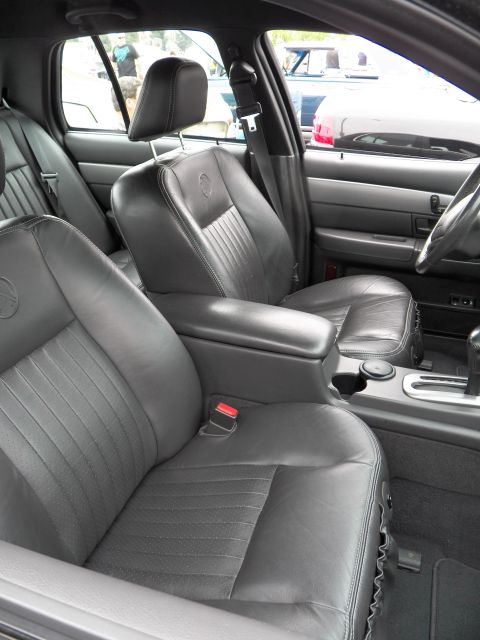 2003 Ford Crown Victoria - View of black leather front bucket seats and console-mounted shifter inside a four-door sedan