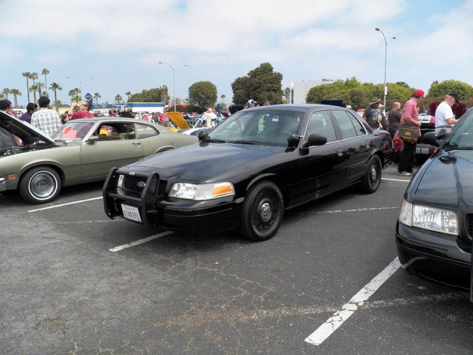 Black Ford Crown Victoria Police Interceptor with push bar parked at car show