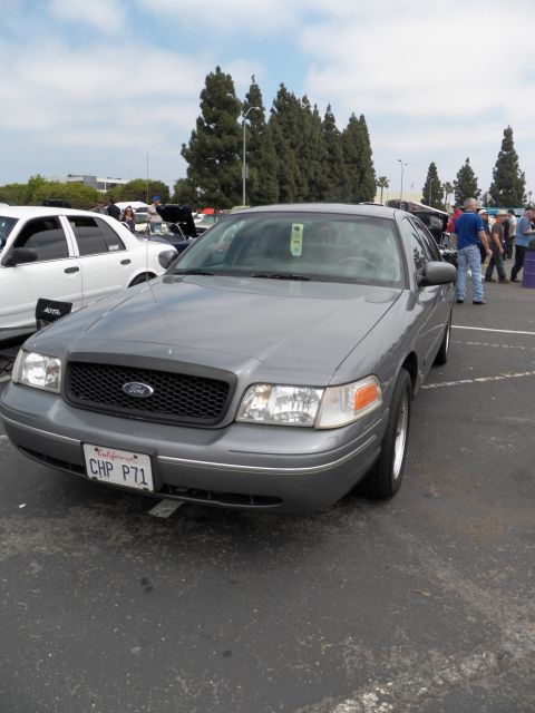 2003 Ford Crown Victoria - Front three-quarter gray Crown Victoria with Ford grille badge and California plate reading CHP P71