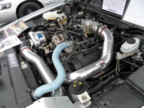 2003 Ford Crown Victoria - Detail of a modified V8 with belt-driven supercharger, alternator and polished intake tubes