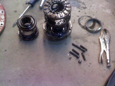 1988 Ford Bronco - Disassembled differential components and tools laid out on a workshop floor.