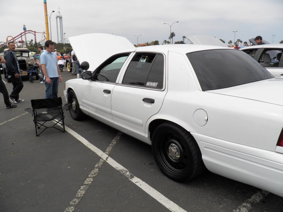White Ford Crown Victoria sedan side profile with hood and trunk open