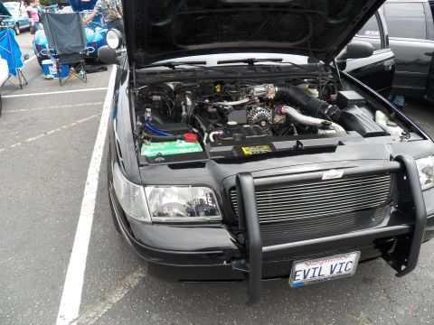 2003 Ford Crown Victoria - Close front three-quarter of a modified Ford sedan showing engine and grille guard