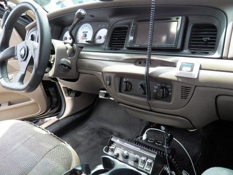 2003 Ford Crown Victoria - Cabin view of a Ford sedan with woodgrain trim, gauges and floor-mounted shifter