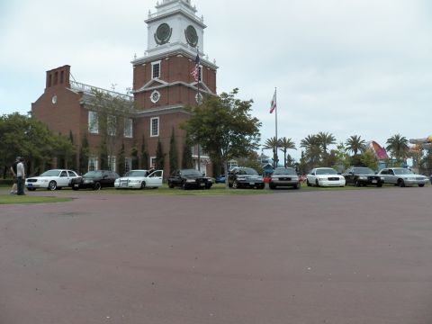 2003 Ford Crown Victoria - Lineup of black and white sedans on grass fronting a brick Independence Hall replica.
