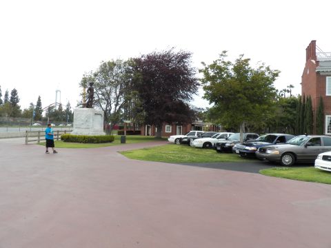 2003 Ford Crown Victoria - Sedans lined on grass by a soldier statue with a person in blue crossing the red path
