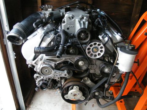 2004 Ford Crown Victoria - Ford SVT engine assembly, likely from a performance vehicle, mounted on an orange stand.