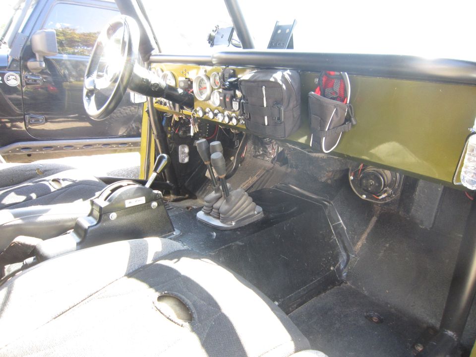 Interior view of off-road vehicle with multiple shifters and gauges