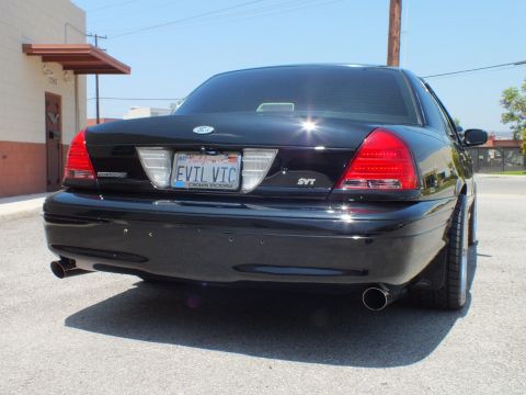 2003 Ford Crown Victoria - Tail of murdered-out Crown Vic, EVIL VIC plate and SVT badge, dual chrome tips.