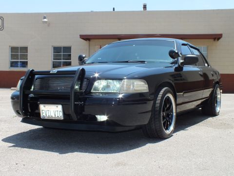 2003 Ford Crown Victoria - Front-quarter of blacked-out Crown Vic with brush guard and EVIL VIC plate.