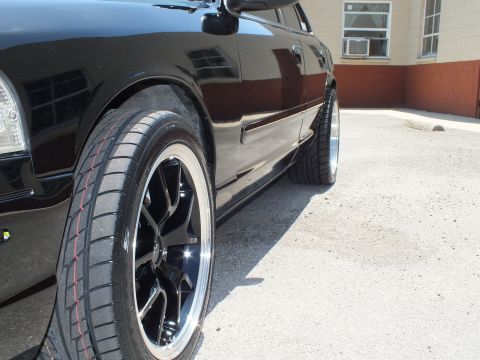 2003 Ford Crown Victoria - Detail of chrome-lip black wheel and red-stripe tire on lowered Crown Vic.