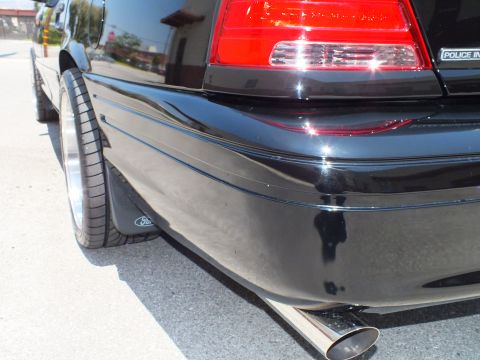 2003 Ford Crown Victoria - Detail of rear quarter and Police Interceptor badge with chrome exhaust tip.