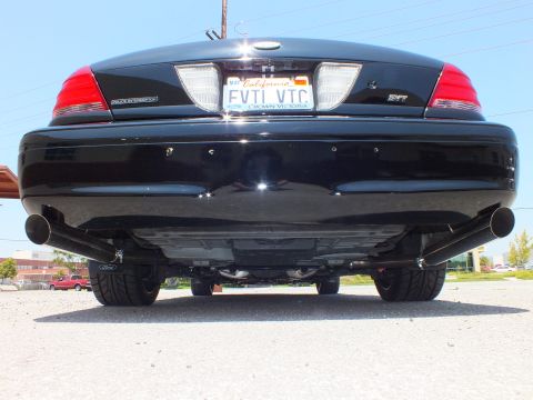 2003 Ford Crown Victoria - Low rear angle of a black Ford sedan exposing the exhaust, suspension and FVTL VTC plate.