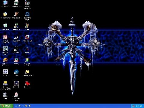 1995 Ford Bronco - A computer desktop displays a dark fantasy wallpaper with icons and a central icy sword graphic.