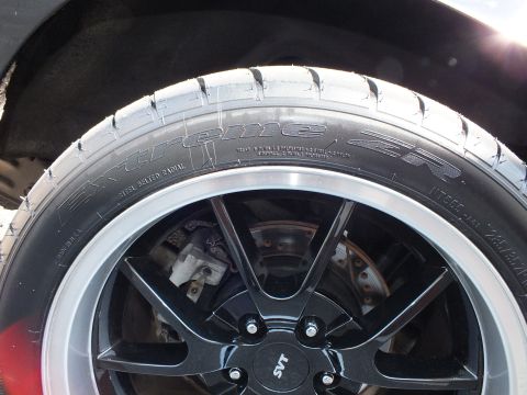 2003 Ford Crown Victoria - Detail of an SVT-center-cap black wheel, Extreme ZR tire sidewall and cross-drilled brake rotor.