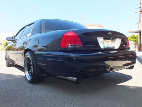 2003 Ford Crown Victoria - Rear of a black Crown Victoria showing a California license plate, single side-exit tip and low ride height.
