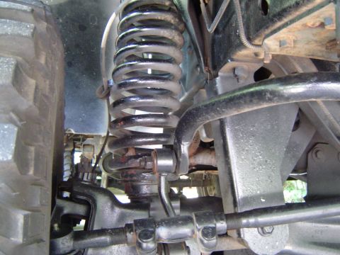1989 Ford Ranger - Close-up view of the front suspension system, including a coil spring and sway bar, with visible text from Supermotors.net.