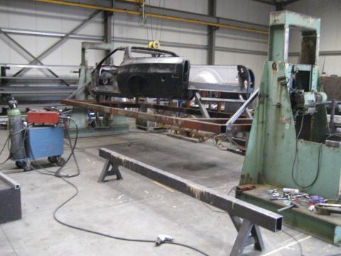 1973 Ford Ranchero - A car body is undergoing repairs or reconstruction in a workshop environment.