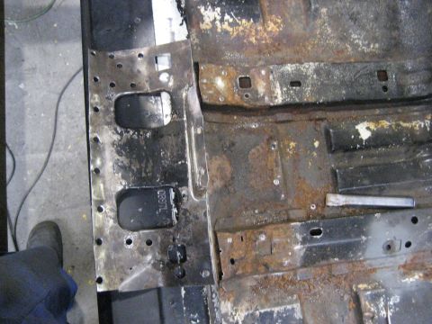 1973 Ford Ranchero - Close-up of a heavily rusted vehicle floor pan, showing signs of wear and tear.