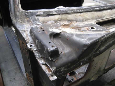 1973 Ford Ranchero - Close-up of a car's structural frame, indicating significant rust and repair.