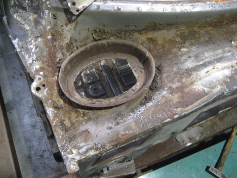 1973 Ford Ranchero - Close-up view of heavily rusted metal, showing a circular opening in what appears to be a vehicle's floor pan.