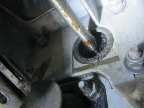 1997 Dodge 3500 - A close-up view of an engine component showing signs of an oil leak and rust.