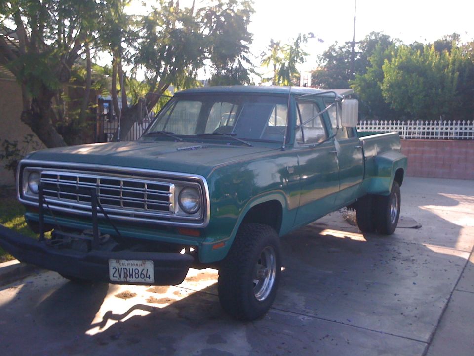 Green dually pickup truck with aftermarket bumper and dual rear wheels
