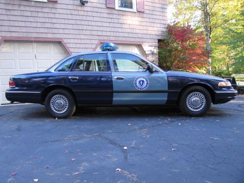 2001 Ford Crown Victoria - This 2001 Ford Crown Victoria, marked as a Massachusetts State Police vehicle, is seen from the side.
