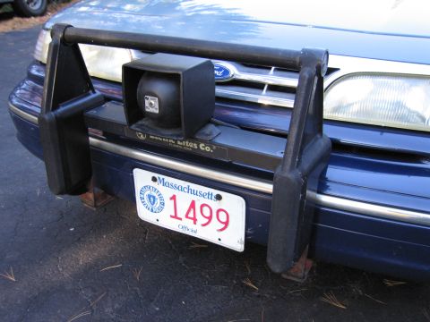 2001 Ford Crown Victoria - A Ford Crown Victoria is equipped with a push bar and a spotlight mounted to the front.