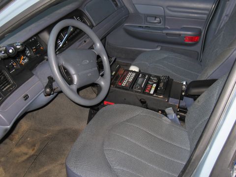 2001 Ford Crown Victoria - Interior view of a 2001 Ford Crown Victoria, equipped with police radio and control equipment.