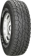 1976 Ford Bronco - This is a close-up shot of an all-terrain tire mounted on a shiny chrome wheel.
