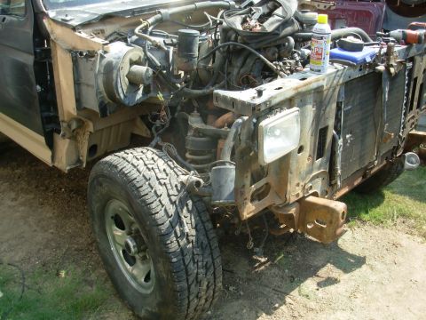 1983 Ford Bronco - This heavily modified 1980s Ford Bronco is missing its front body panels, revealing its engine and suspension components.