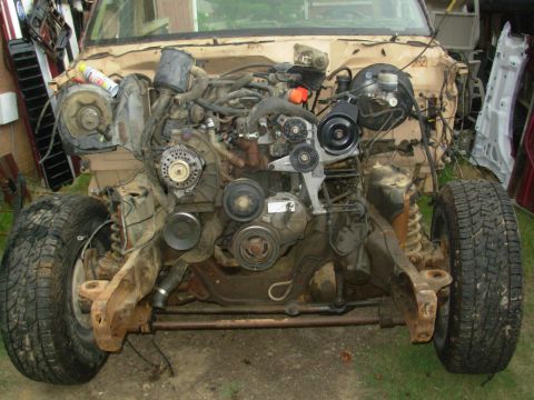 1983 Ford Bronco - The engine and front chassis of a Ford Bronco are visible, with the body panels removed.