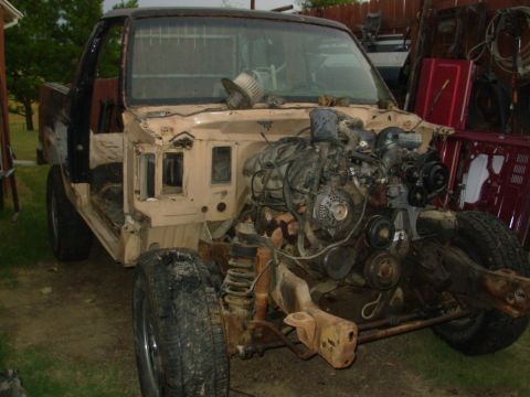 1983 Ford Bronco - This heavily disassembled 1980s Ford Bronco shows its chassis and exposed engine, with some body panels present.