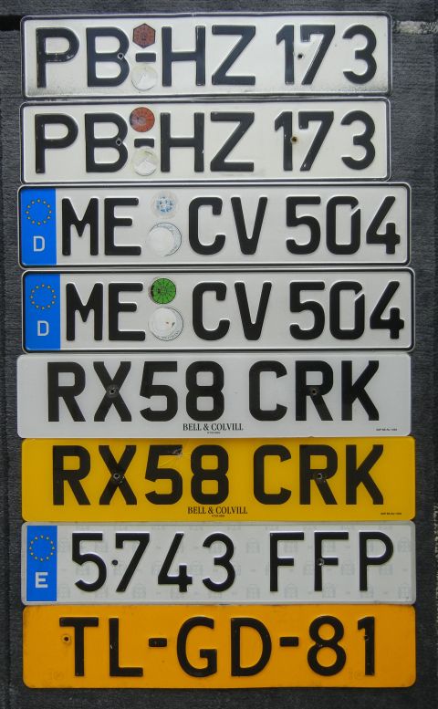 1999 Lincoln Town Car - A collection of license plates from different regions and eras are piled on top of each other.