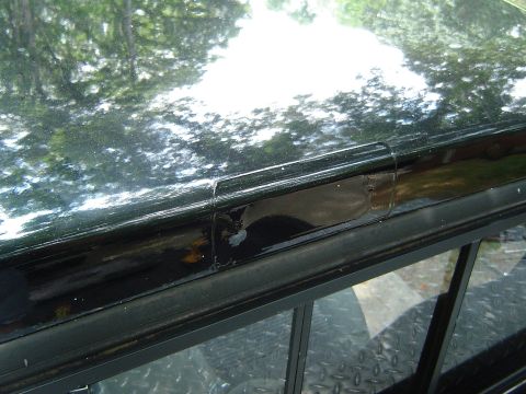1989 Ford Ranger - Close-up view of a black truck bed rail showing wear and tear.