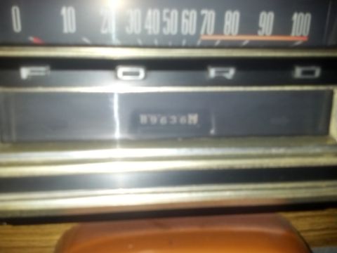 1969 Ford F-250 - Close-up of a 1969 Ford F-250's dashboard, displaying the odometer and part of the speedometer.