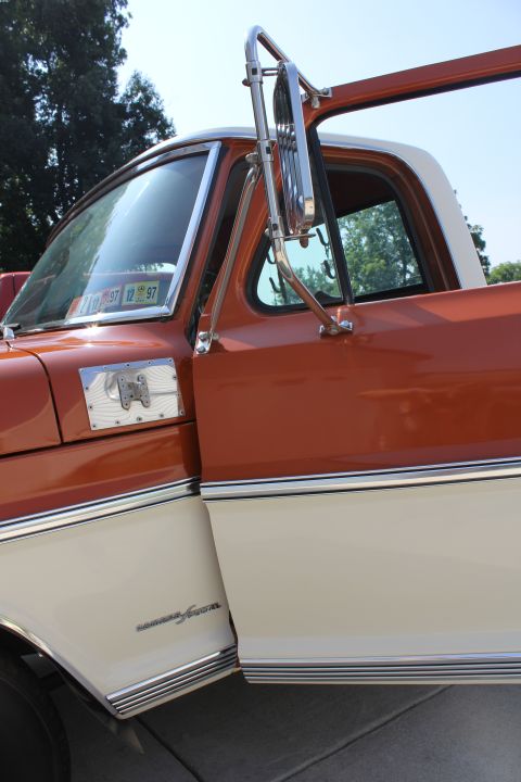 1969 Ford F-250 - The side panel of this pickup truck features a "Custom Special" emblem and extensive chrome trim.