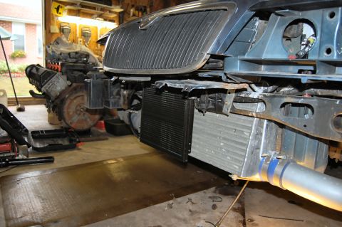 1985 Mercury Grand Marquis - Front end components and engine assembly are visible in a garage setting.