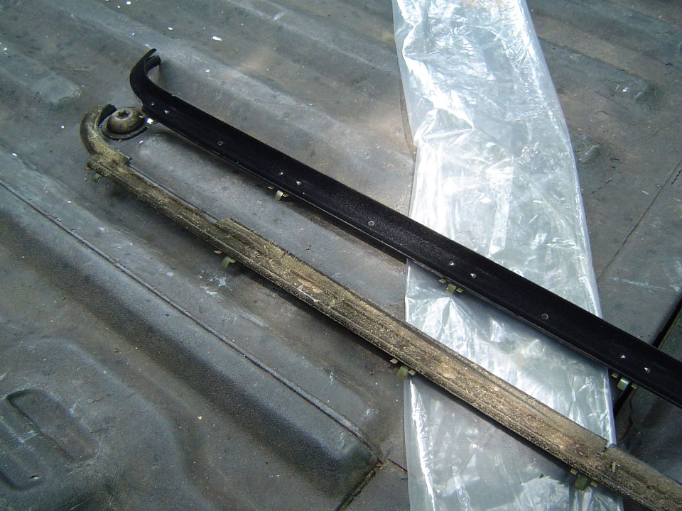 Door seal next to a new one, on a truck bed