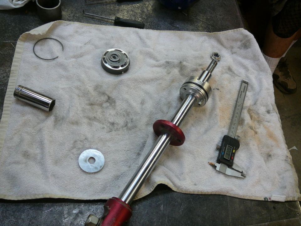 disassembled shifter assembly with socket, washer, and calipers on a towel