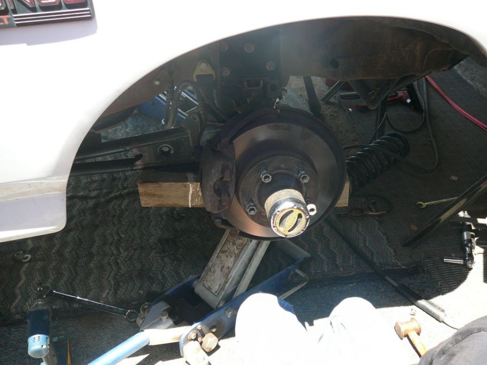 Front wheel hub and brake assembly with a jack supporting the vehicle