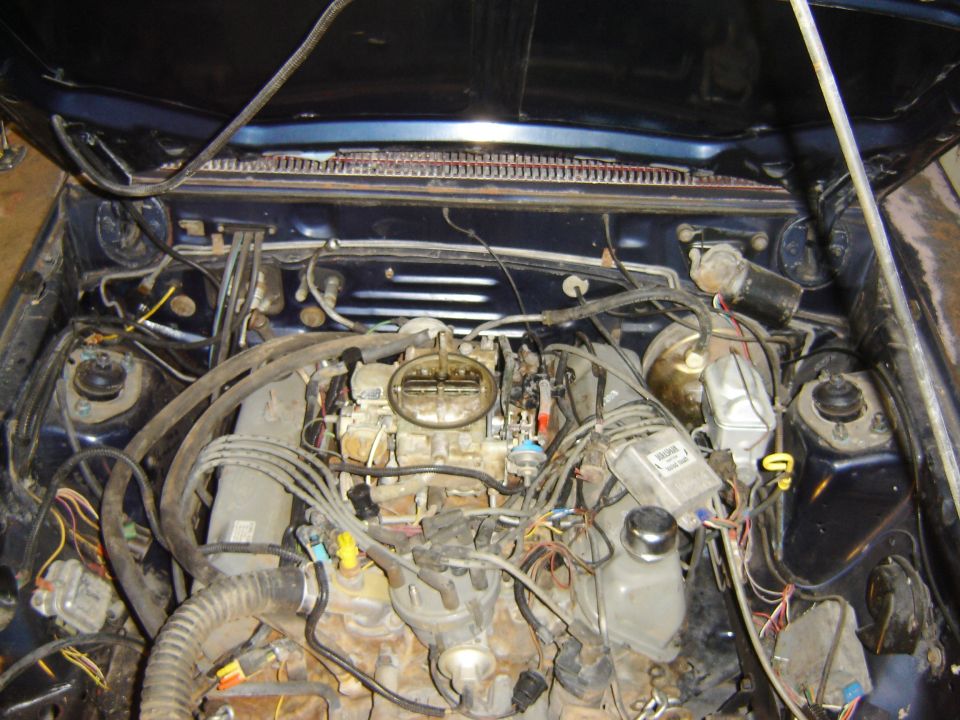 1982 Mercury Zephyr engine bay with carburetor and wiring visible