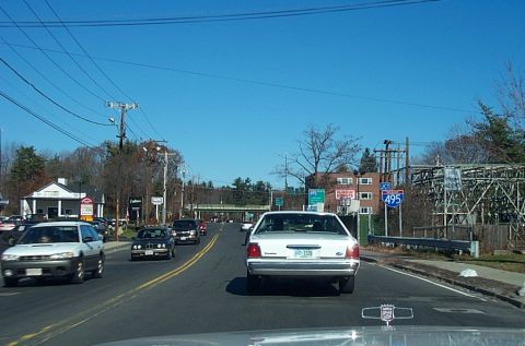 1991 Ford LTD Crown Victoria - Rear view of a 1991 Ford Crown Victoria LTD on a highway, with other vehicles visible.