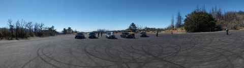 2003 Ford Crown Victoria - Wide shot of a car gathering on a skid-circled pad surrounded by chaparral.