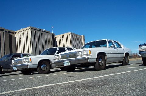 1991 Ford LTD Crown Victoria - 1991 Ford Crown Victoria LTD police cars parked in front of a large building.