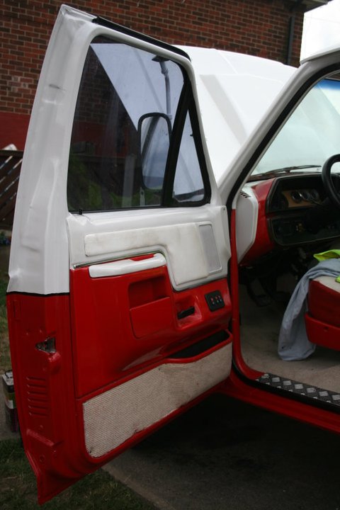 1989 Ford Bronco - Close-up view of the driver's side door panel and interior of a vehicle.