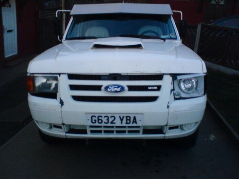 1989 Ford Bronco - Front view of a white Ford Ranger, showing its grille and headlights.