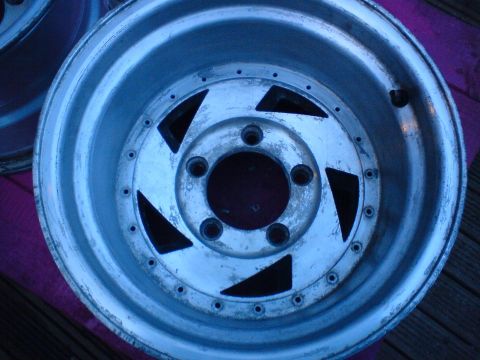 1989 Ford Bronco - Close-up view of a single aluminum wheel, showing its design and bolt pattern.
