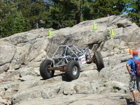 1989 Ford Bronco - A custom-built off-road buggy navigates a challenging rock crawling course.